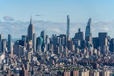 an aerial view of new york city with the empire building in the foreground and other tall buildings