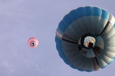 two hot air balloons flying in the sky