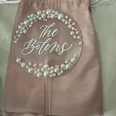 the bottom of a bag with pearls on it and an inscription that says, the bottoms