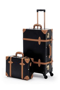 two pieces of luggage sitting next to each other on top of a white surface with brown handles