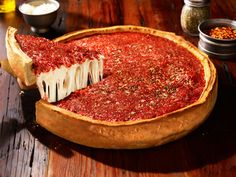 a deep dish pizza with cheese and sauce