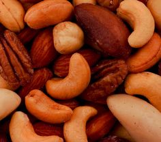 mixed nuts and raisins are shown close up