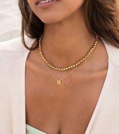 One Perfect Puka on One Perfect Beaded Chain This simple necklace speaks for itself, the elements of the ocean around your neck and elegant enough to wear every day or layer with your other favorite pieces. ﻿Product Details Waterproof and Sweat proof Warranty Included Stainless Steel, 18k Gold Plated Hypo-Allergenic Size: 15" with 2" extender Gold Single Strand Charm Necklace For Everyday, Everyday Gold Single Strand Charm Necklace, Gold Single Strand Necklace For Layering, Dainty Gold Necklace, St Tropez, Sweat Proof, Shell Necklaces, Simple Necklace, Summer Accessories