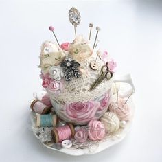 a teacup filled with lots of yarn and buttons