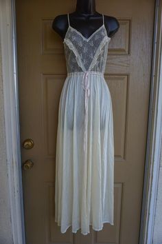 White maxi nightgown by La Femme De Vanity Fair. No size labeled - estimated small.  In good vintage condition. Measurements taken across front laid flat18" across front armpit to armpit14" across waist52" length White Fitted Feminine Nightgown, Cream Sheer Nightgown For Sleep, Vintage White Nightgown, Sheer Cream Nightgown For Sleep, Vintage Cream Nightgown For Loungewear, Vintage Sheer Sleepwear For Night, Vintage Sheer Nightgown For Sleep, Cream Vintage Nightgown For Bedtime, Vintage Cream Nightgown For Bedtime