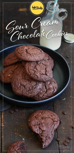 chocolate cookies on a plate next to a bottle of milk and glass of milk with the words, our cream chocolate cookies