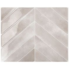 a white tile wall with an arrow pattern in the center and diagonals on it