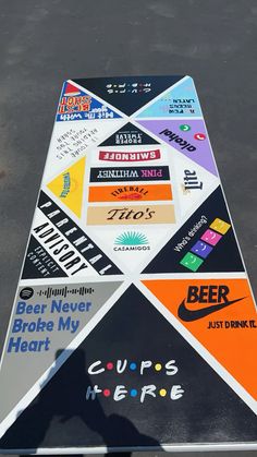 there is a very large triangle shaped sign with many different logos and words on it