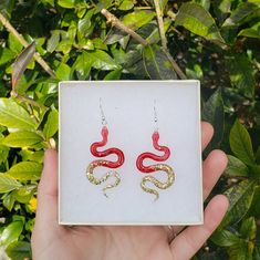 Red and Gold Snake Earrings  These snake earrings are perfect for any snake lover 🐍 made from a lightweight resin with sterling silver hooks 🌼 Gold Snake Earrings, Snake Shedding, Jacksonville Nc, Snake Lovers, Snake Earrings, Snake Necklace, Gold Snake, Red And Gold, Jewelry Earrings Dangle