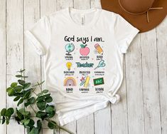 a white t - shirt with the words god says i am surrounded by other things