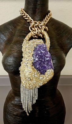 Here's a piece I had forgotten to list. A set a rough purple amethyst into a baroque style sculpture, painted it metallic gold and then heavily studded it with rhinestones. An angled silver tone rhinestone fringe sways from the bottom left hand corner which gives additional drama to the piece. The pendant measures 12" x 4" from the bail to the bottom of the rhinestone fringe. A warm gold large cable link chain suspends the piece and has an approximate 9" drop on each side. It closes with an xl f Rocker Chic Accessories, Jewelry Vendor, Rhinestone Fringe, Unique Pendant Necklace, Gemstone Choker, Long Statement Necklace, Pagan Jewelry, Mermaid Necklace, Baroque Style