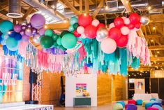 balloons and streamers are hanging from the ceiling