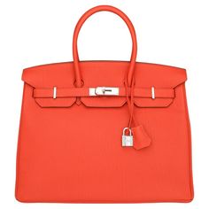 Hermès Birkin Bag 35cm Capucine Togo Leather with Palladium Hardware Stamp Q_Year 2013. This bag is still in excellent condition. The leather still smells fresh, and it still retains its original shape. The hardware is still very shiny. A truly stunning rouge-orange colour, combined with beautiful palladium hardware, which would go well with any outfit. The colour was introduced in the 2012 Spring Summer collection and is placed beside the iconic Hermes Orange colour. Capucine, in French, refers to the flower nasturtium and will also draw everybody’s attention. Togo leather is renowned for its timeless appeal and exceptional qualities. Crafted from calfskin, it undergoes meticulous tanning processes to accentuate its natural beauty and durability, making it one of the most popular leathers Hermes Birkin Bag 35cm, Pochette Louis Vuitton, Hermes Orange, Alberto Giacometti, Orange Colour, Togo Leather, Jane Birkin, Bright Spring, Spring Summer Collection