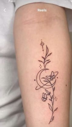 a woman's arm with a flower and vine tattoo on the back of her leg