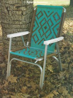 a blue lawn chair sitting next to a tree