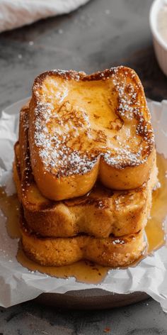 french toast stacked on top of each other with powdered sugar