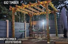 an outdoor patio with lights strung from the pergolated arbor and wooden decking