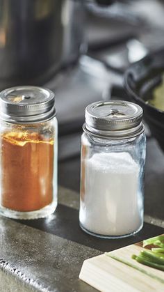 two jars filled with food sitting on top of a counter