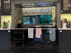 a kitchen with an oven, sink and cabinets