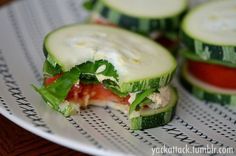 a sandwich with cucumbers and tomatoes on it