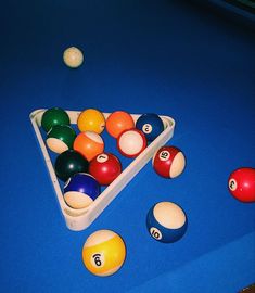 billiards and pool balls on a blue table