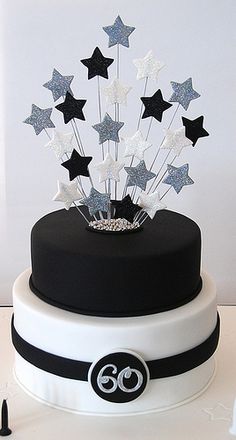 a black and white cake with silver stars on top