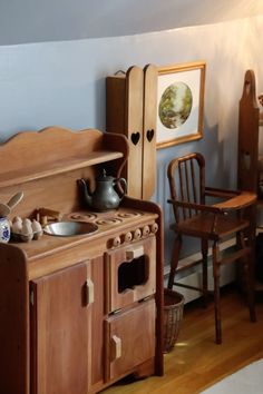 an old fashioned wooden stove with pots and pans on it