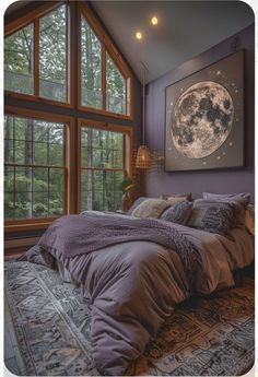 a bed sitting under a large window next to a wall mounted art piece in a bedroom