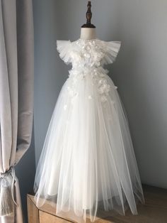 A beautiful, phenomenal baptism gown. Body with a separate skirt. The bodysuit is very delicate. Made of cotton and elastic lace. Very comfortable for a child. Attachable skirt. 3d flowers. Skirt length 70 cm (27). Very soft tulle. Free short skirt. Pure white dress. Applications - first photo. White Tulle First Communion Dress With Ruffles, Elegant Tulle Baptism Dress For Ceremony, Cream Tulle Baptism Dress For Ceremony, White Tulle Gown For First Communion, White Tulle Gown For Confirmation, Cream Tulle Baptism Gown, Cream Tulle Gown For Baptism, Elegant White First Communion Dress For Ceremony, Delicate White Tulle Dress