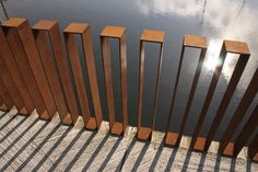 a wooden fence next to the water