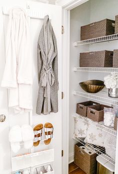 the closet is organized with baskets, towels, and other items to keep things fresh