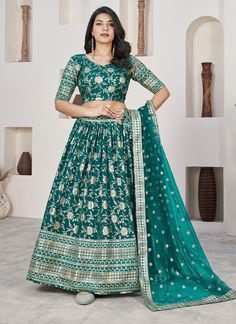 Add a touch of elegance and style to your wardrobe with our Teal Green Weaving Jacquard Dola Silk Lehenga Choli. Made from high-quality fabric, this readymade ensemble is perfect for any Indian wedding or festive occasion. The intricate weaving and jacquard design will surely make you stand out in the crowd. The unstitched blouse can be customized upto 46 inches. Do Note: All the accessories shown are for styling purpose only. Slight color variation may occur due to photographic reasons. Occasio Teal Green Blouse, Green Lehenga Choli, Lehenga Choli Designs, Ghaghra Choli, Lehenga Choli For Women, Silk Lehenga Choli, Choli For Women, Lengha Choli, Green Lehenga