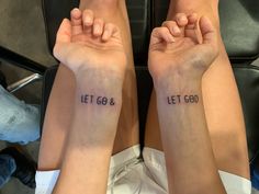 two people with tattoos that say let go and let god