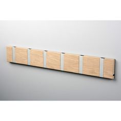 a wall mounted wooden plaque with four horizontal strips