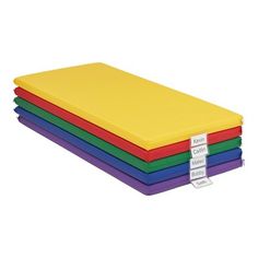 four different colored foam sheets stacked on top of each other with tags attached to them