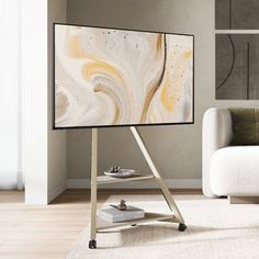 a flat screen tv sitting on top of a stand in a living room next to a white couch