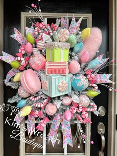 a decorated front door with pink, green and blue decorations