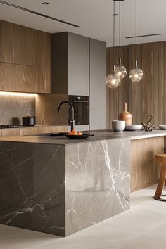 a modern kitchen with marble counter tops and wooden cabinets, along with pendant lights hanging from the ceiling