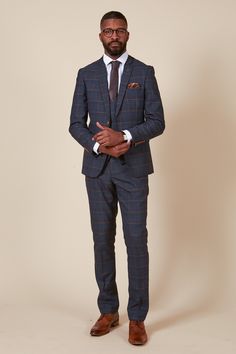 As worn by WBA Midfielder, John Swift. This three-piece suit is a showstopper! Boasting a fashionable Prince of Wales style check, it instantly elevates your tailoring game. The dual-lined blazer features a modern camouflage print as a bonus, while contrast waistcoat elevates the look to the next level. Features Slim fit Single-breasted blazer Double-breasted waistcoat Notch lapel Double back vent Four button cuff Double button blazer fastening Waistcoat adjuster straps Complimentary pocket squa Navy Check Suit, Rust Tie, Tan Accessories, Double Breasted Waistcoat, Accessories Model, Check Suit, Checked Suit, A Prince, Checked Trousers