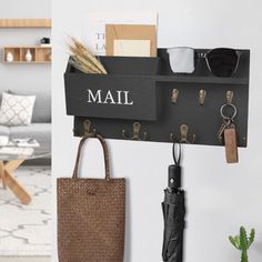 a wall mounted shelf with keys, umbrella and other items hanging on it's side