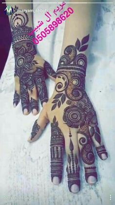 two hands with henna designs on them