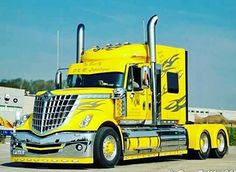 a yellow semi truck parked in a parking lot