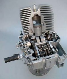 an image of a motorcycle engine that is made out of metal and has gears attached to it