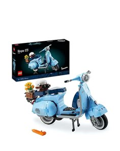 a blue moped is shown in front of a box with flowers on the back