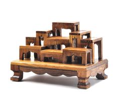 a wooden bench with several pieces of furniture stacked on top of each other in the shape of squares and rectangles