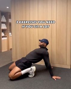 a man in black shirt and cap doing exercises on the floor with his legs crossed