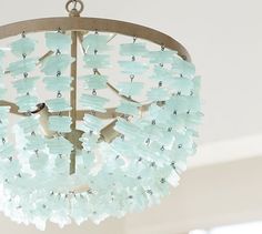 a chandelier with frosted glass pieces hanging from it's center circle