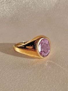 Antique 9k yellow gold ring from the United Kingdom c 1916 featuring a beautiful light lilac faceted amethyst in a bezel setting. Good antique condition, slight wear and fade to amethyst. Size: 7.5 resizable* Weight: 3.5 grams Band: 11.6 mm (front), 1.5 mm (back) Amethyst: 9.0 mm x 7.5 mm Hallmarks: crown for gold, 375 for 9k, "R" for 1916, 'FM' for makers mark Luxury Purple Signet Ring For Engagement, Luxury Purple Classic Signet Ring, Luxury Purple Elegant Signet Ring, Luxury Purple Hallmarked Signet Ring, Luxury Classic Purple Signet Ring, Luxury Classic Amethyst Signet Ring, Luxury Antique Cabochon Signet Ring, Amethyst Signet Ring, Lilac Amethyst