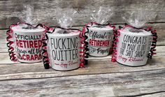 three coffee mugs wrapped in red and black ribbon