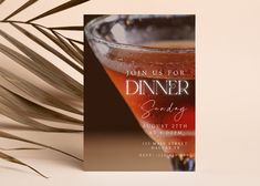 an elegant dinner party card with a drink in a coupe glass and palm frond